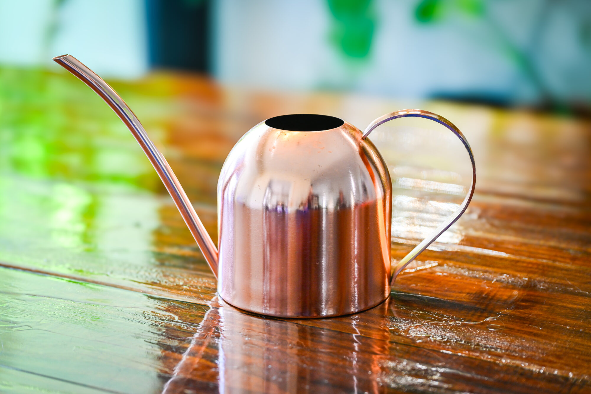 bronze watering can sitting on a table